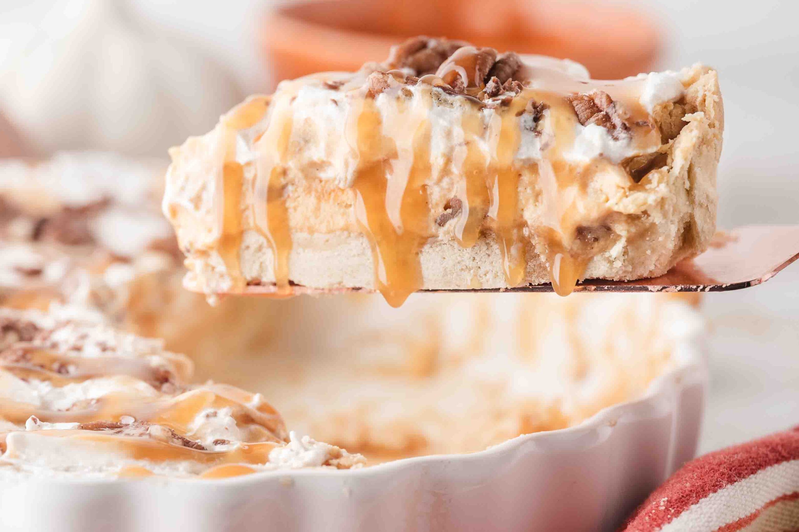 Homemade no bake pumpkin pie being sliced and served to a plate