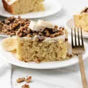 Banana cake slice topped with cream cheese frosting