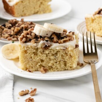 Banana cake slice topped with cream cheese frosting