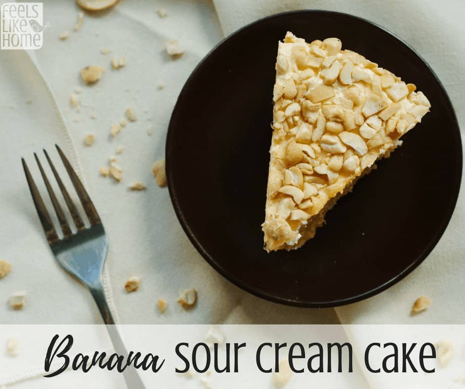 a slice of banana sour cream cake on a black plate with the title \"banana sour cream cake\"