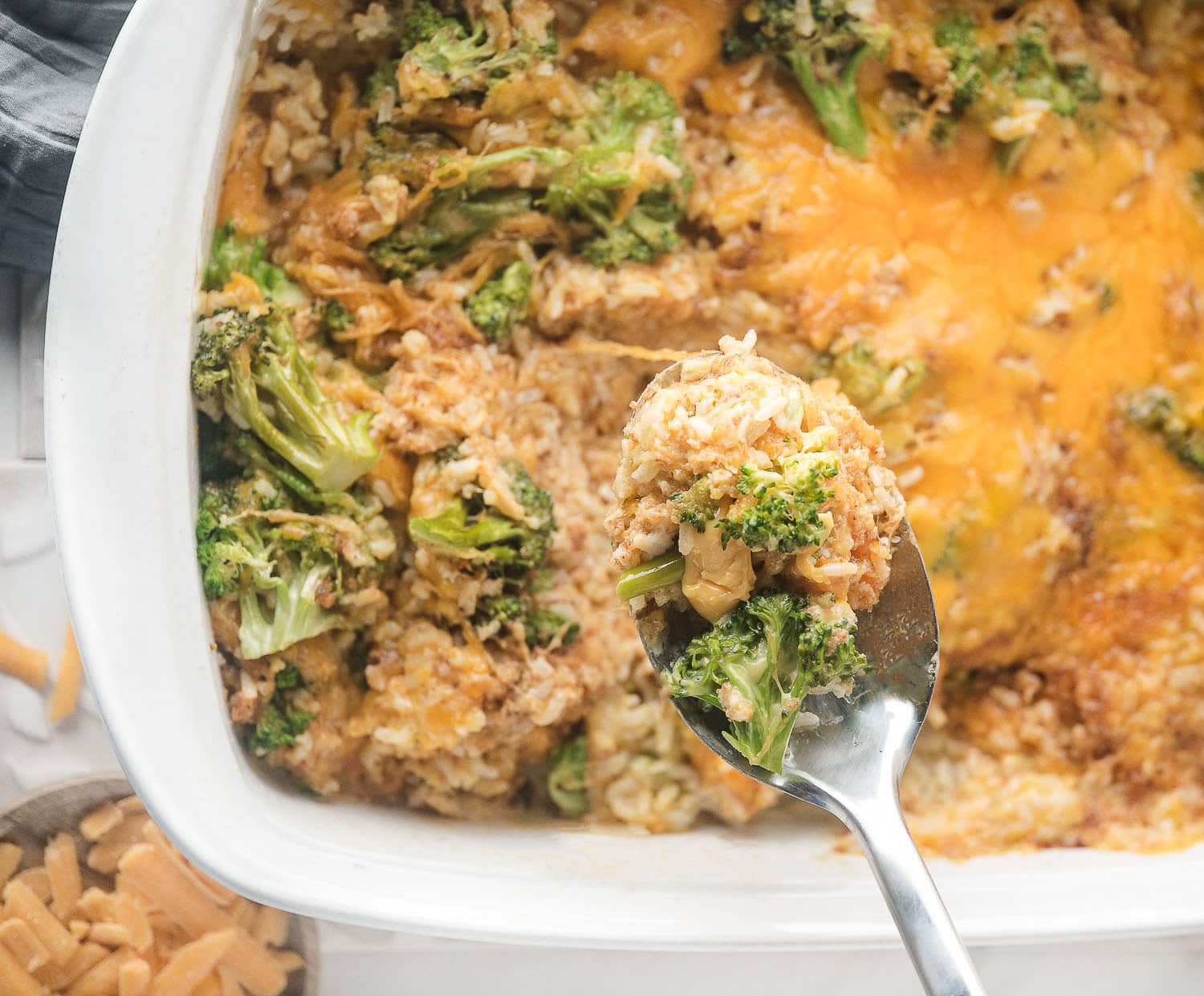 Right out of the oven a warm gooey cheesy broccoli rice casserole is ready to be served. 