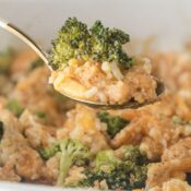 Spoon holding up a serving of broccoli cheese and rice casserole