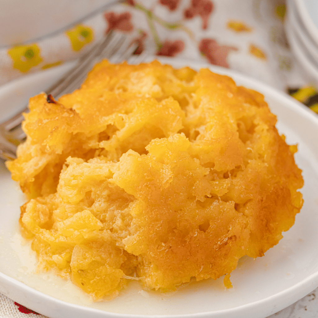 baked pineapple casserole on a white plate