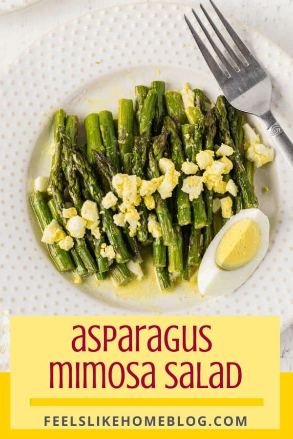 A plate of food on a table, with asparagus Salad and Mimosa Vinaigrette