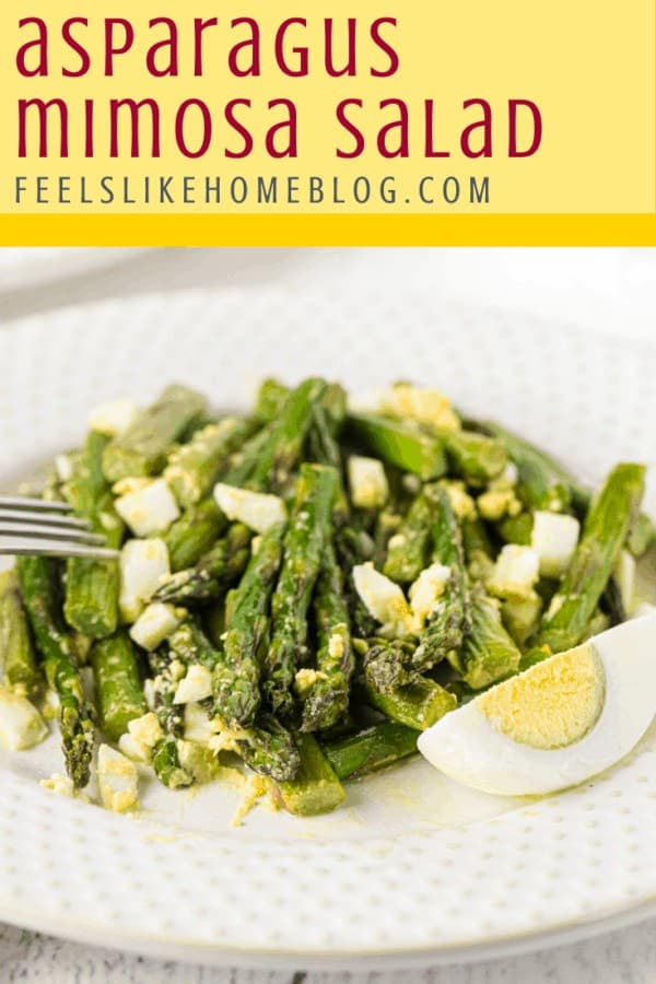 A plate of food, with asparagus and egg Salad and Vinaigrette