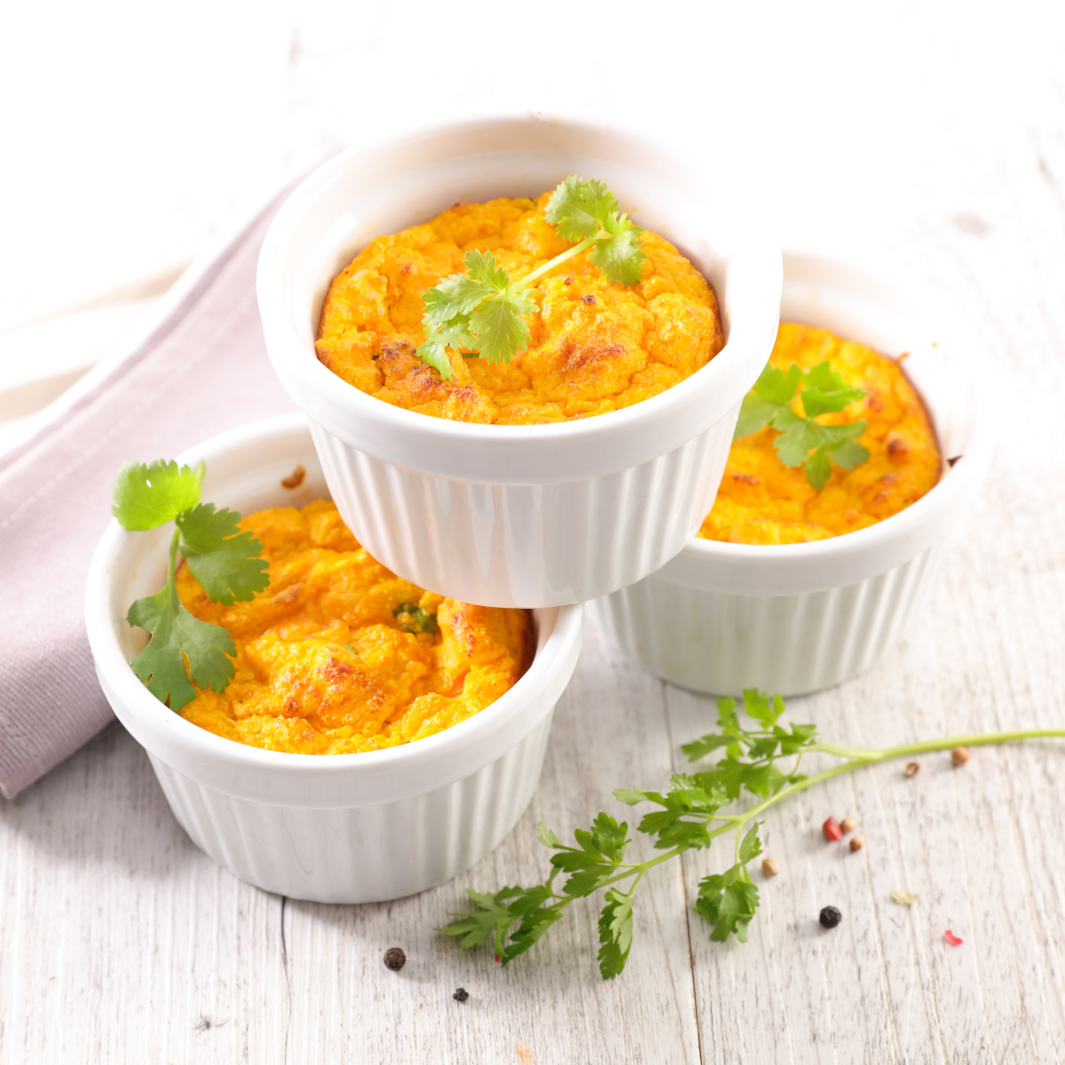 three carrot soufflés stacked in a pyramid