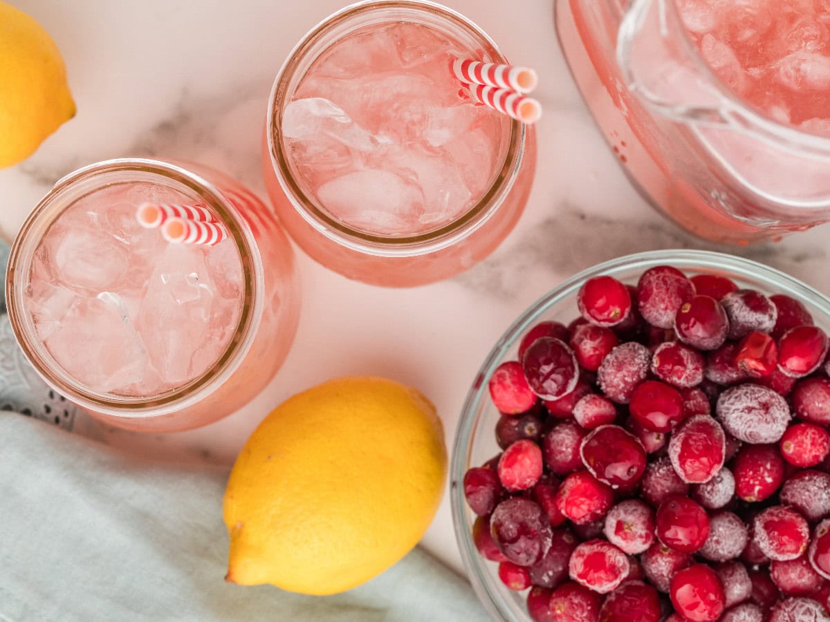 Pink cranberry lemonade with fresh fruit garnish