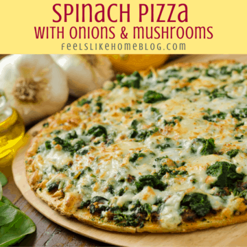 a pizza with spinach, onions, and mushrooms