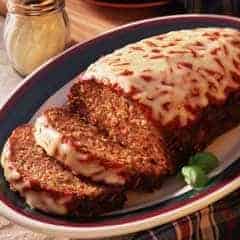 A plate of food on a table, with Meatloaf and Pizza