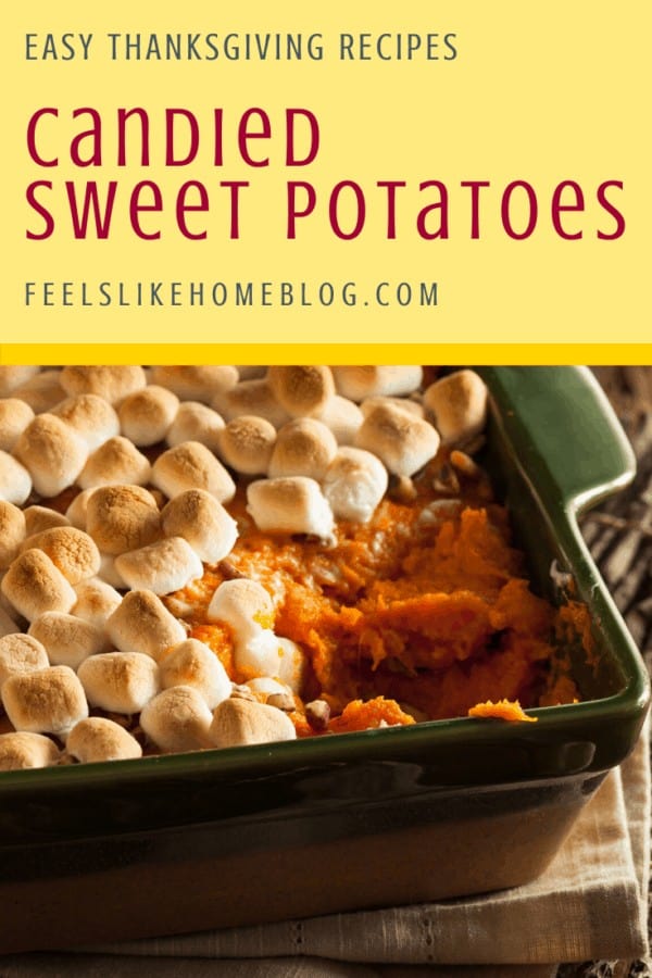 A green casserole dish filled with sweet potatoes and marshmallows