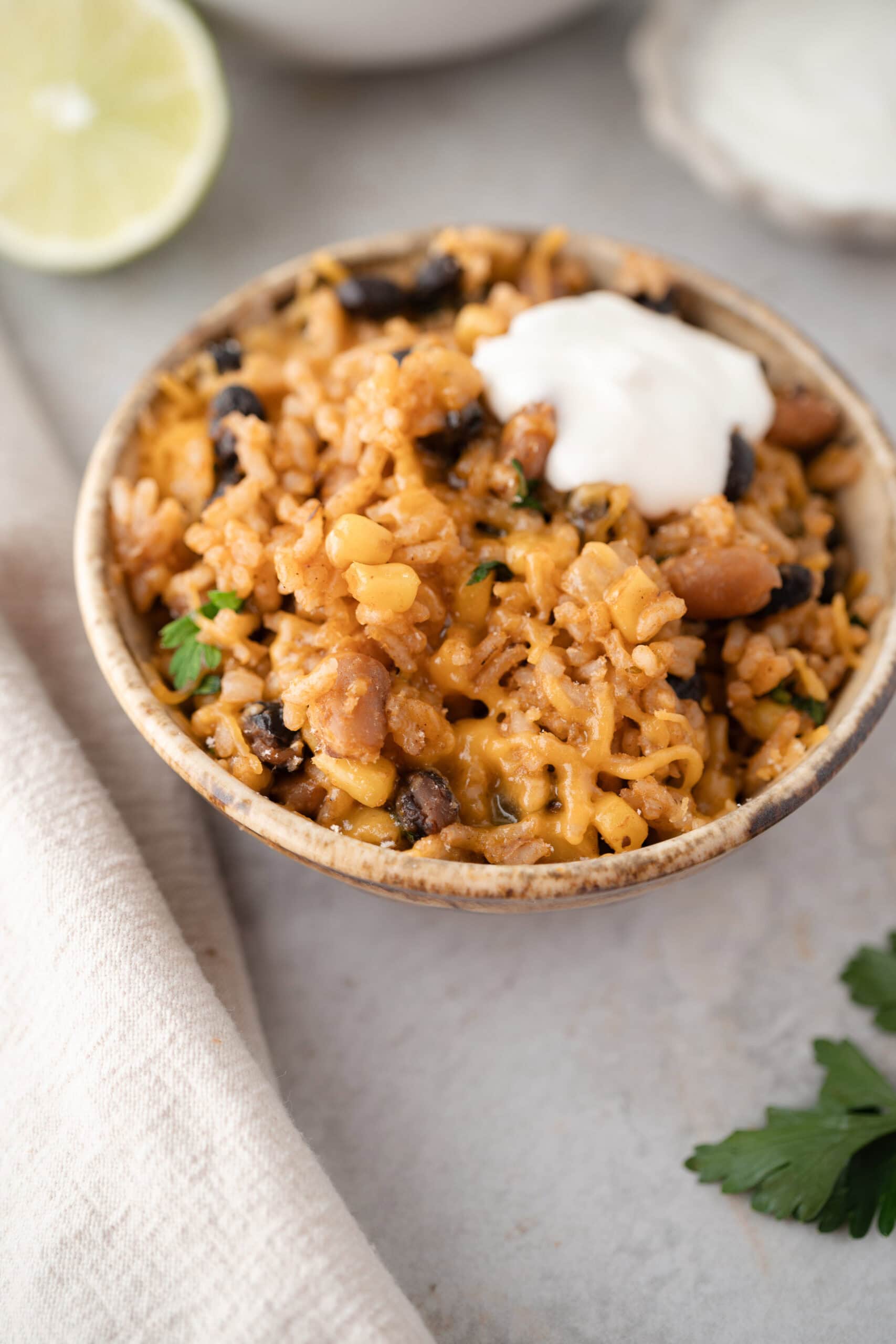 Mexican Beans and Rice served in a bowl with sour cream, ready to be enjoyed