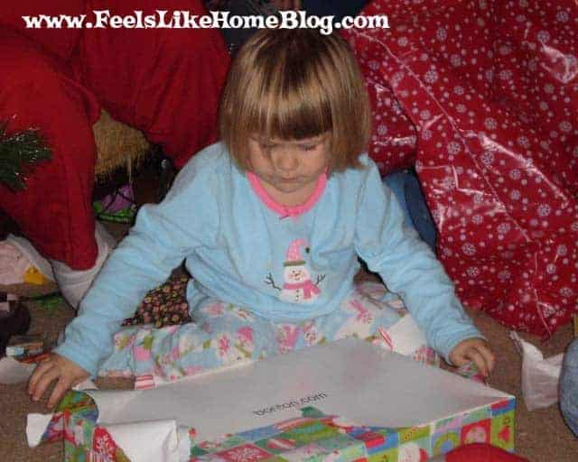 A little girl opening Christmas presents