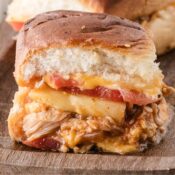 smoky BBQ chicken slider with pineapple, tomato, and cheddar cheese on a King's Hawaiian roll