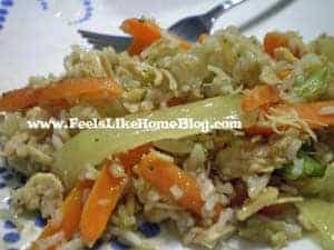 A close up of a plate of food with rice, meat, and vegetables, with Vinaigrette and Cauliflower