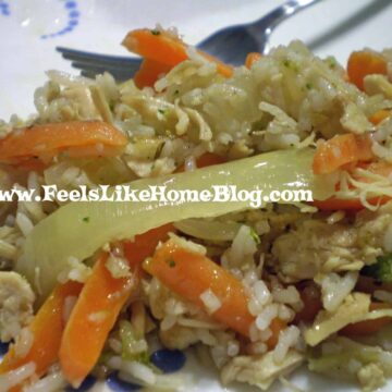 A close up of a plate of food with rice, meat, and vegetables, with Vinaigrette and Cauliflower