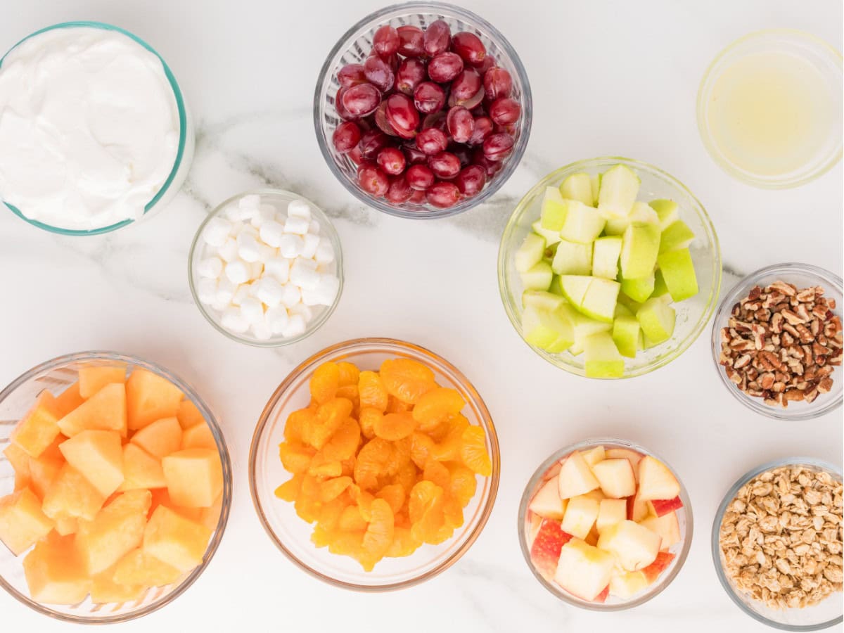 Layered fruit salad ingredients with yogurt dressing