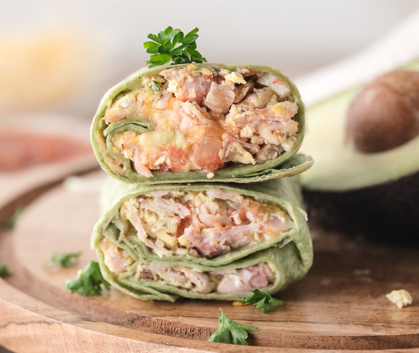 Breakfast burritos all wrapped up and cut in half to easily grab and go