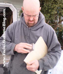 A man sanding a board