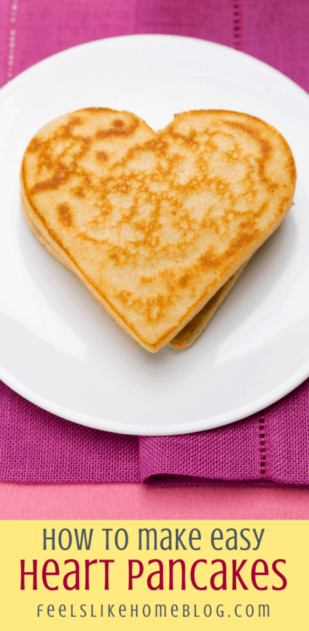 a heart pancake on a white plate with a pink napkin
