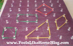 A close up of shapes on the homemade geoboard