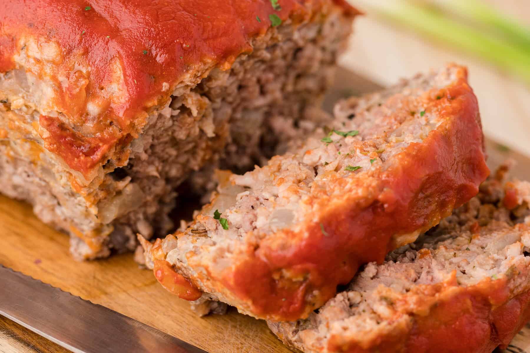 a close up of two slices of easy healthy meatloaf