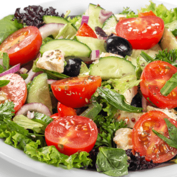 Greek salad with tomatoes, black olives, cucumbers, and feta