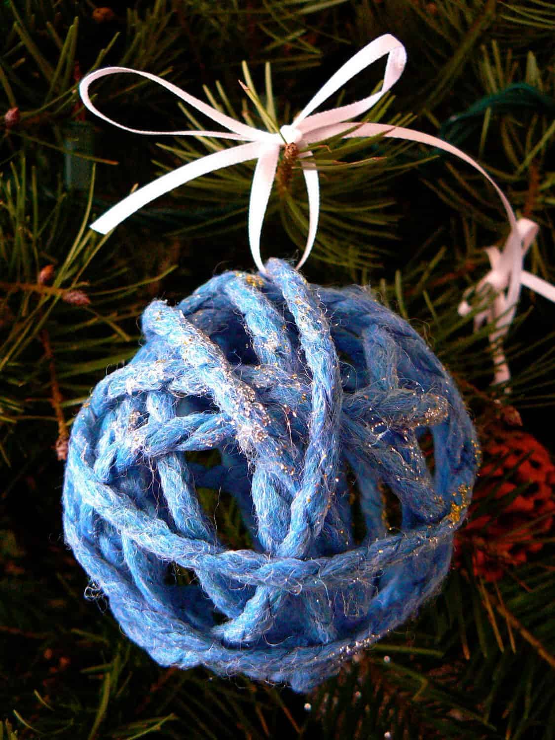 a Christmas tree ornament made of yarn