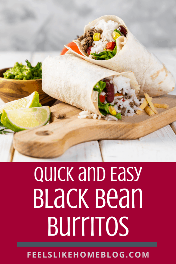 A burrito sitting on top of a cutting board, with black beans and Wrap