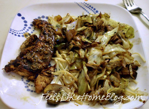 a plate of cabbage and noodles with chicken