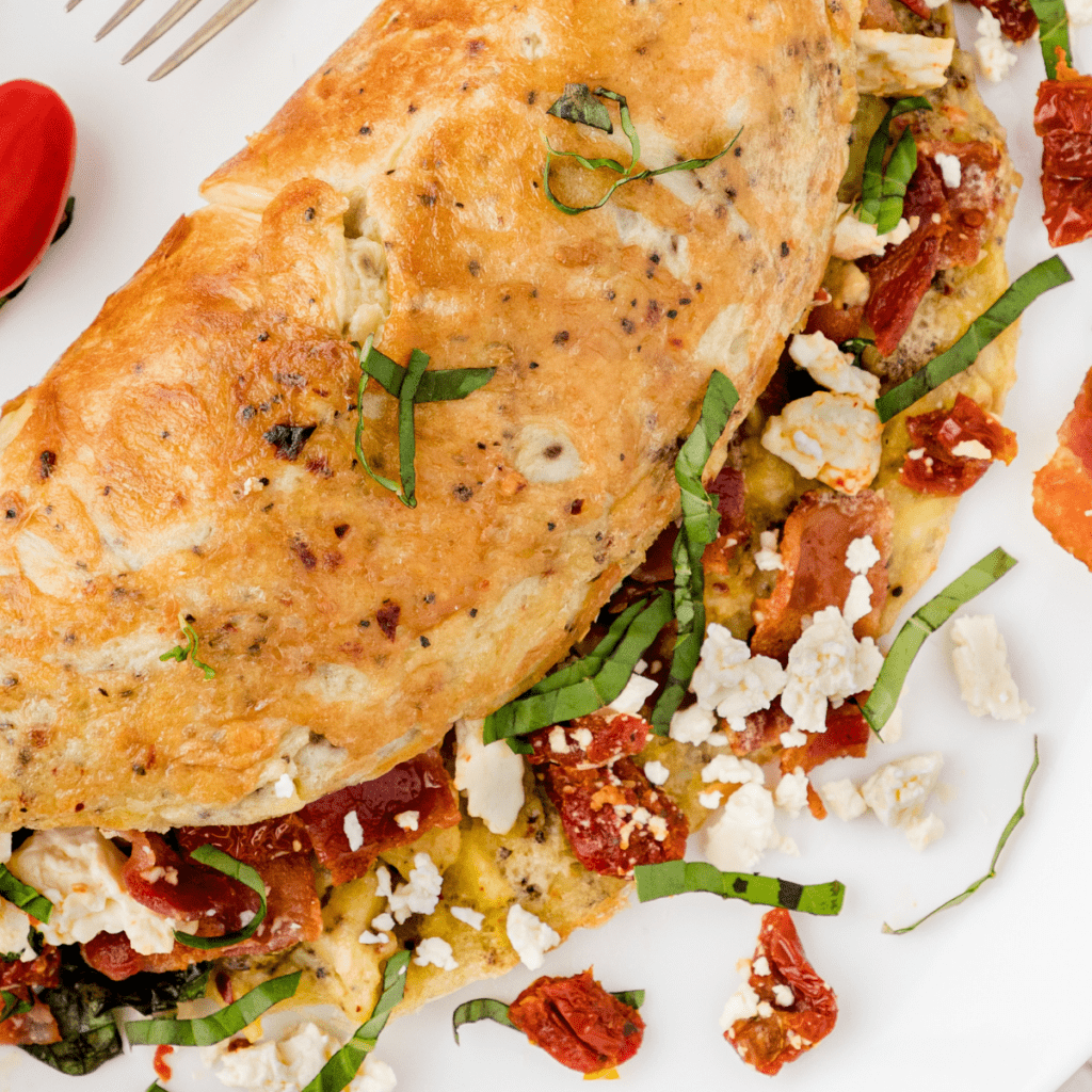 the best bacon omelet recipe with sun dried tomato, basil, and feta cheese