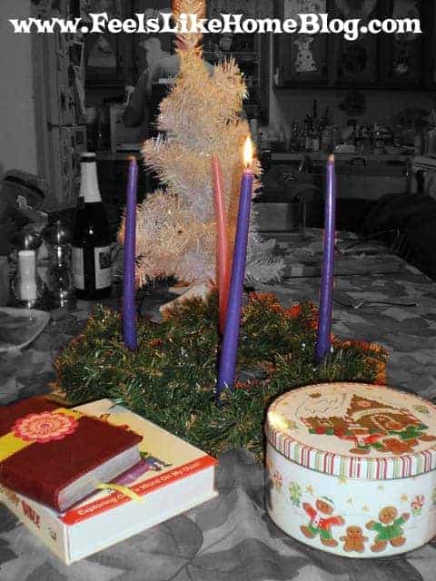 an Advent wreath with a white Christmas tree and a Bible