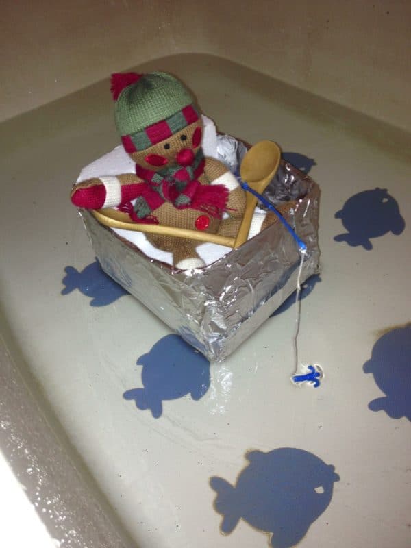 elf on a shelf in a boat in the bathtub