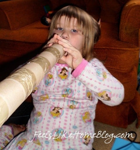 A little girl with a pretend fire hose