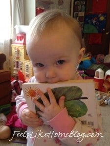 A baby chewing on a book