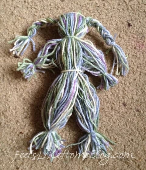 Divide the remaining yarn in half and tie a knot in each half for legs