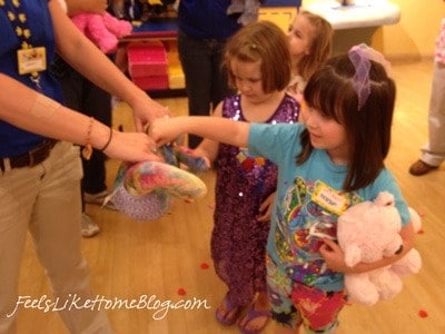 A little girl choosing a heart from Build A Bear Workshop