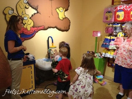 A little girl cleaning her new stuffed animal