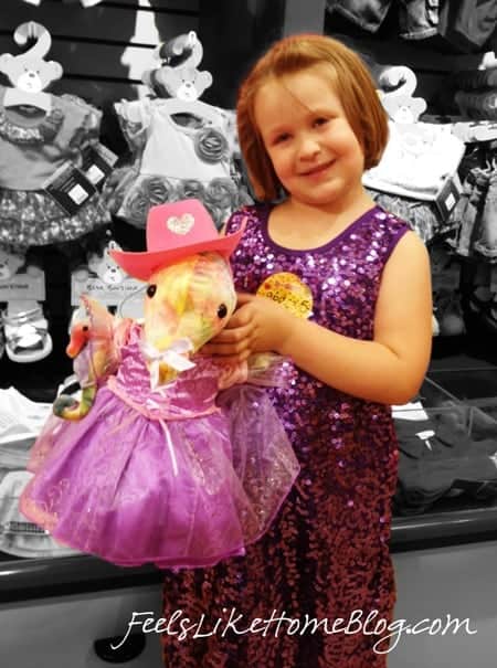 A little girl with her new stuffed animal at her Build A Bear Workshop birthday party