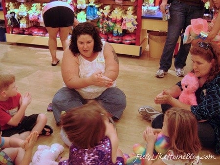 A mom playing on the floor with the kids