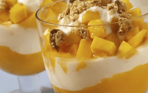 a mango parfait in a glass