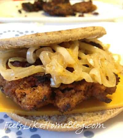 a burger topped with sautéed onions on a flatbread