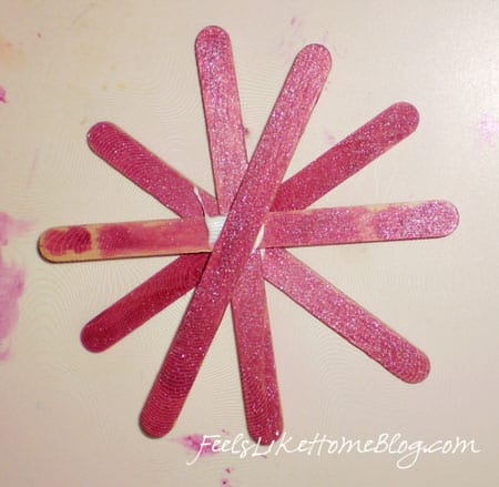 Painted popsicle sticks in the shape of a snowflake