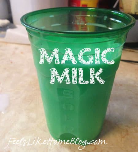 a green plastic cup of milk with the title \"magic milk\"