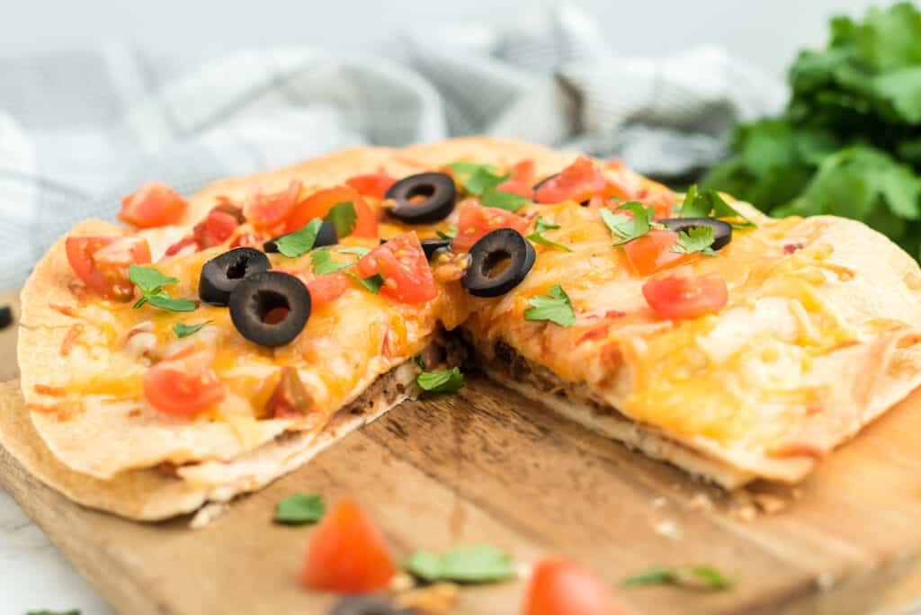 a Mexican pizza with one wedge cut out