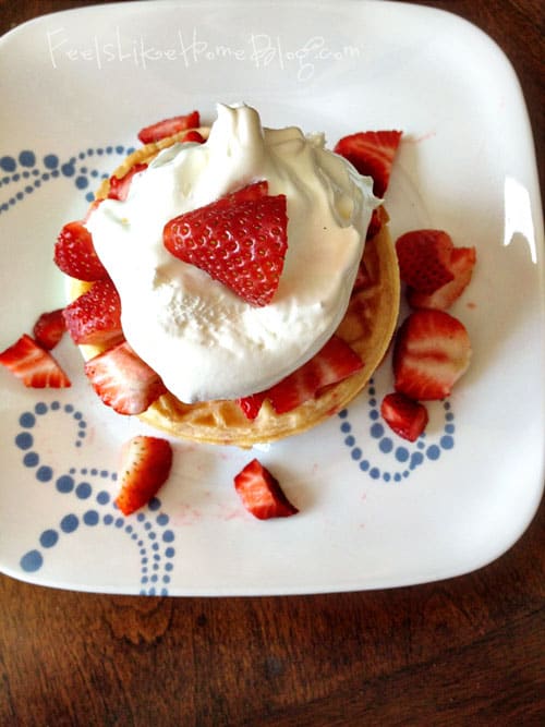 A slice of cake on a plate, with Strawberry and Waffle