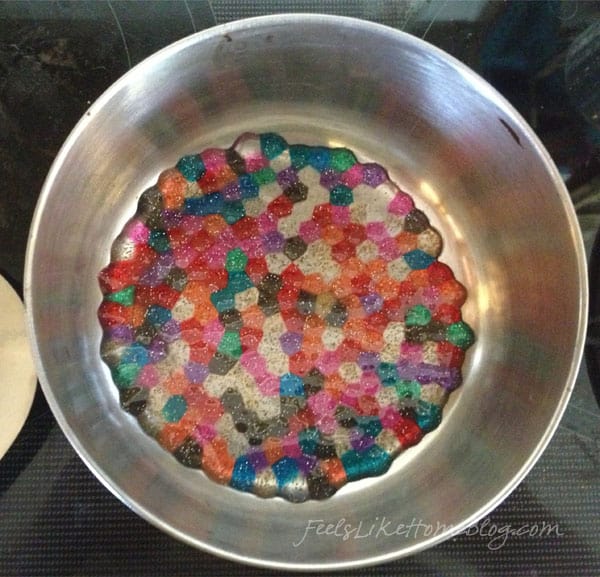 Melted plastic bead suncatchers 1 layer of plastic beads in cake pan. A glass  bead leaves a hole for hanging. 450◦…