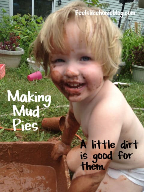 A little girl making mud pies