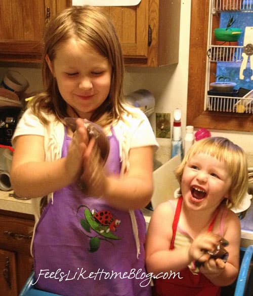 Two little girls excited to squish their astronaut pudding