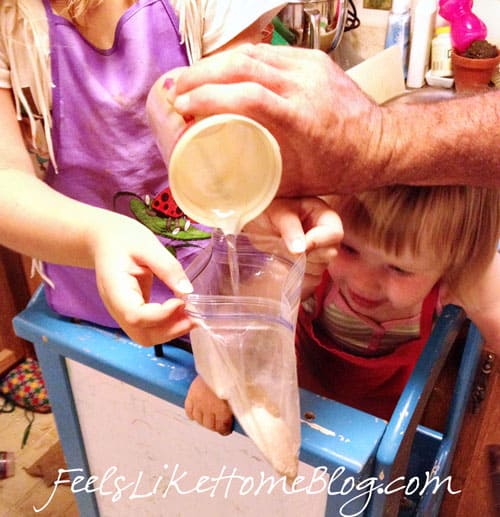 Adding water to the bag of pudding mix and milk powder