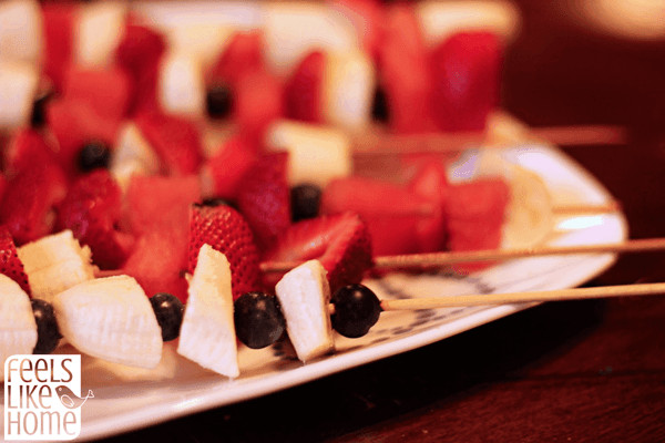 A close up of red white and blue fruit kabobs